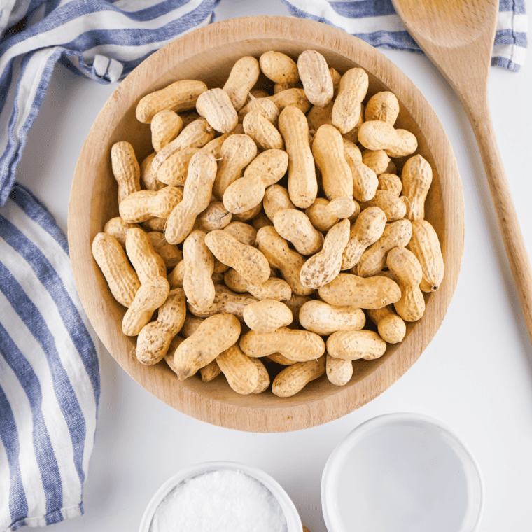 Ingredients needed for Easy Cajun Boiled Peanuts in Crockpot on kitchen table.