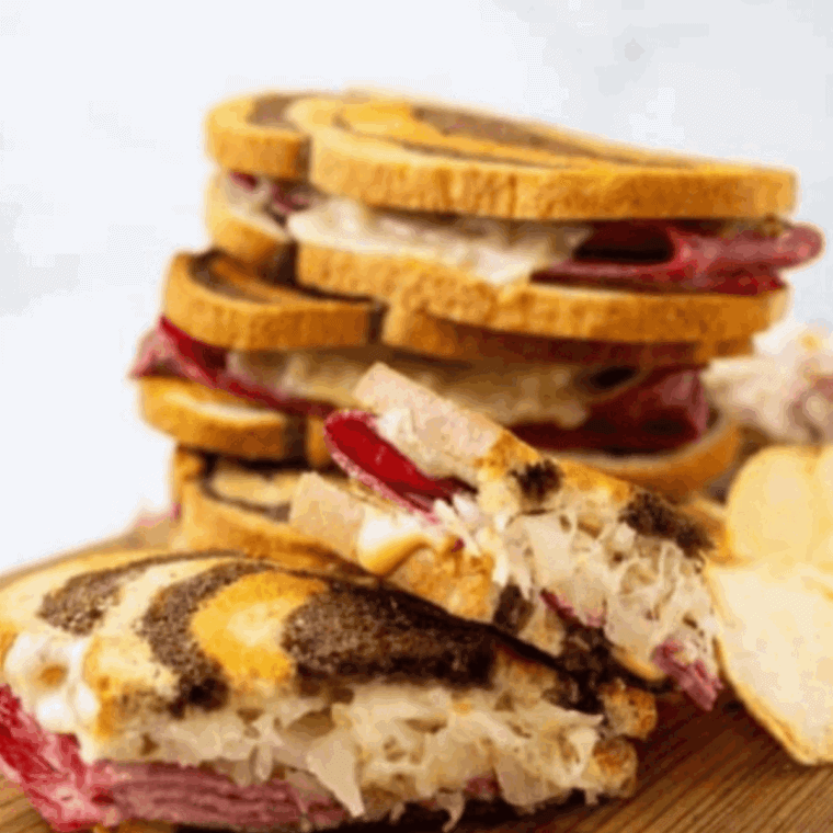 Air Fryer Reuben Sandwich with melted Swiss cheese, corned beef, sauerkraut, and toasted rye bread.