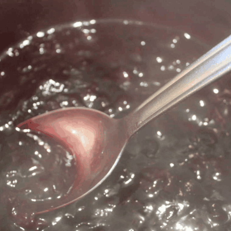 Instant Pot Blueberry Pancake Syrup in a glass jar, rich and vibrant, ready to pour over pancakes.