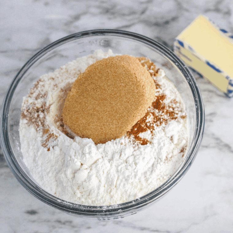 Mixing flour, butter, cream, and egg into scone dough in a bowl