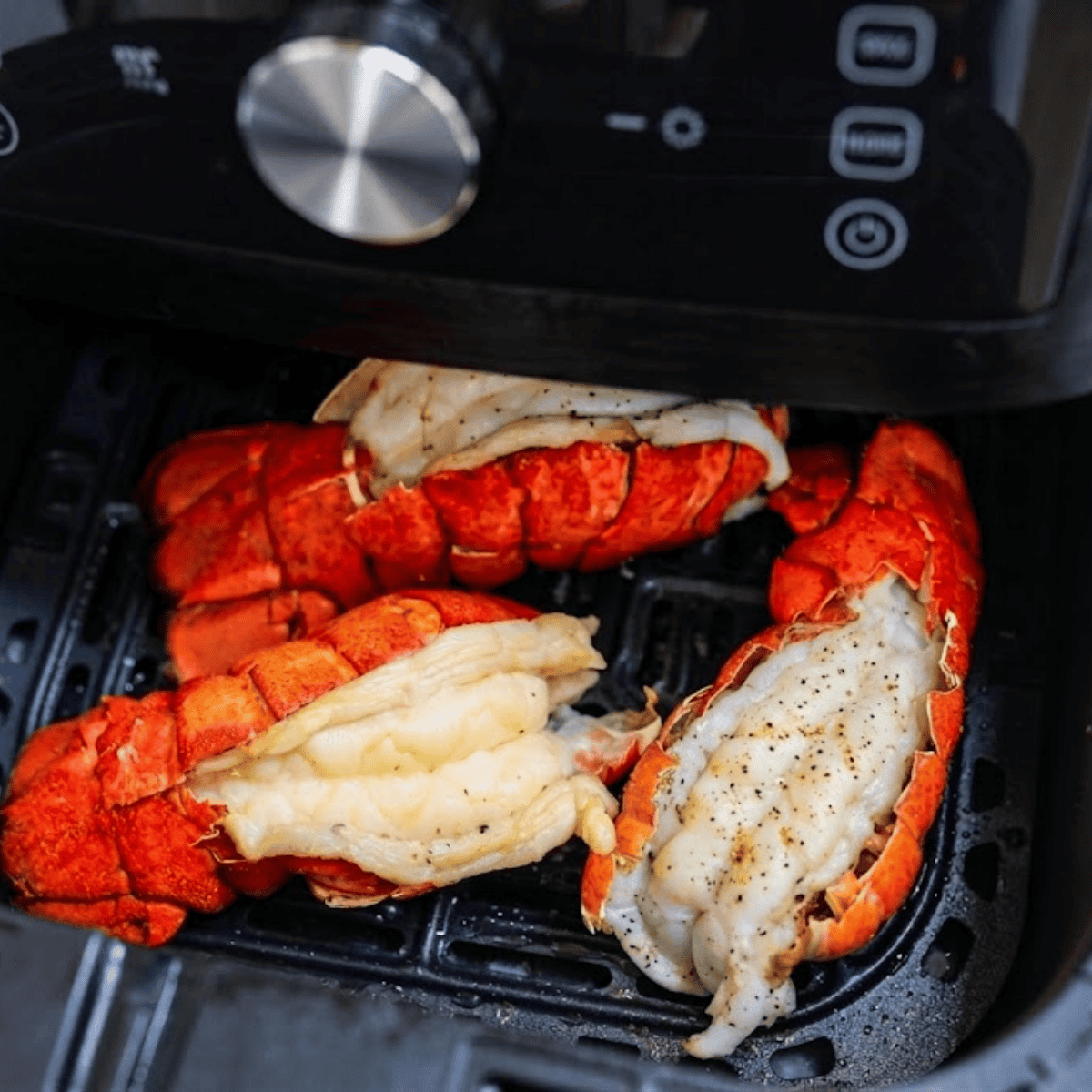 air fryer lobster tails brushed with lemon garlic butter.