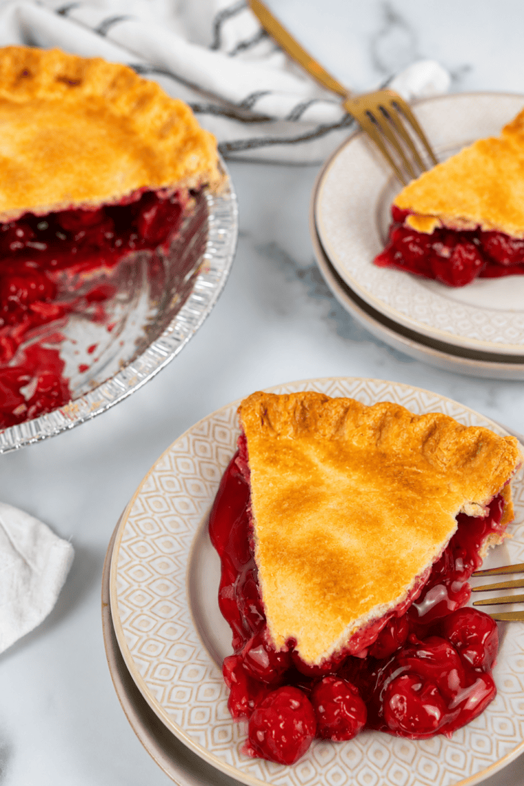 Golden, flaky air fryer cherry pie with a lattice crust and bubbling cherry filling