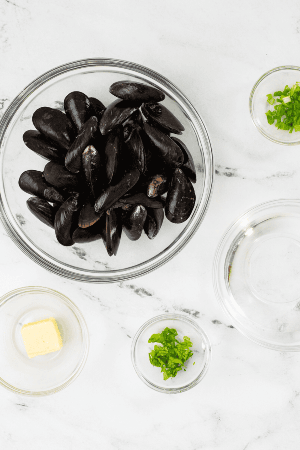 Ingredients needed for Air Fryer Mussels on kitchen table.