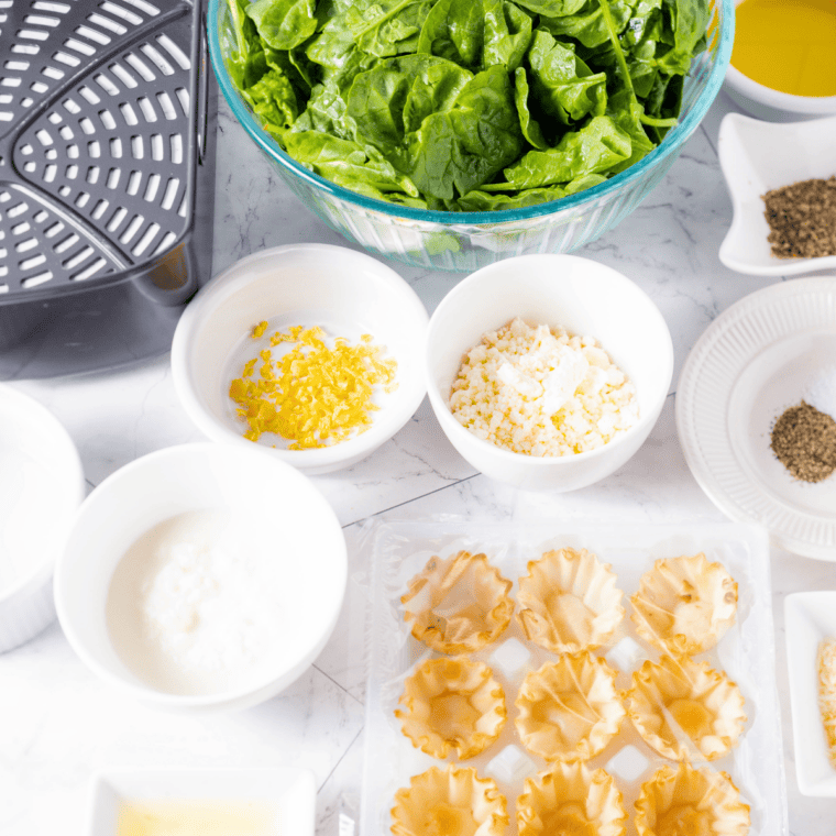 Ingredients needed for Air Fryer Spanakopita Phyllo Cups on kitchen table.