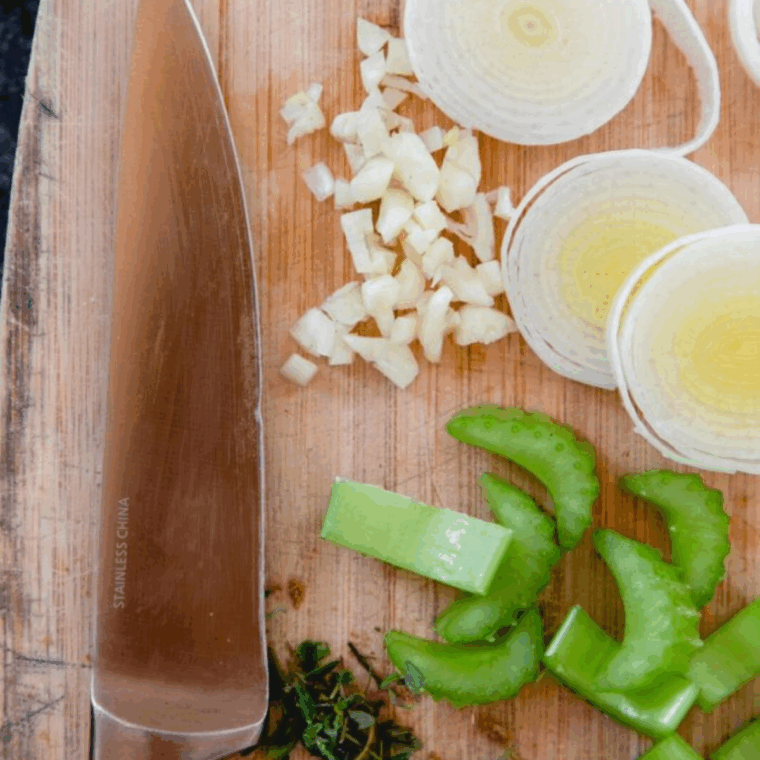 Diced onion, celery, garlic, sage and thyme sautéing in butter in a skillet