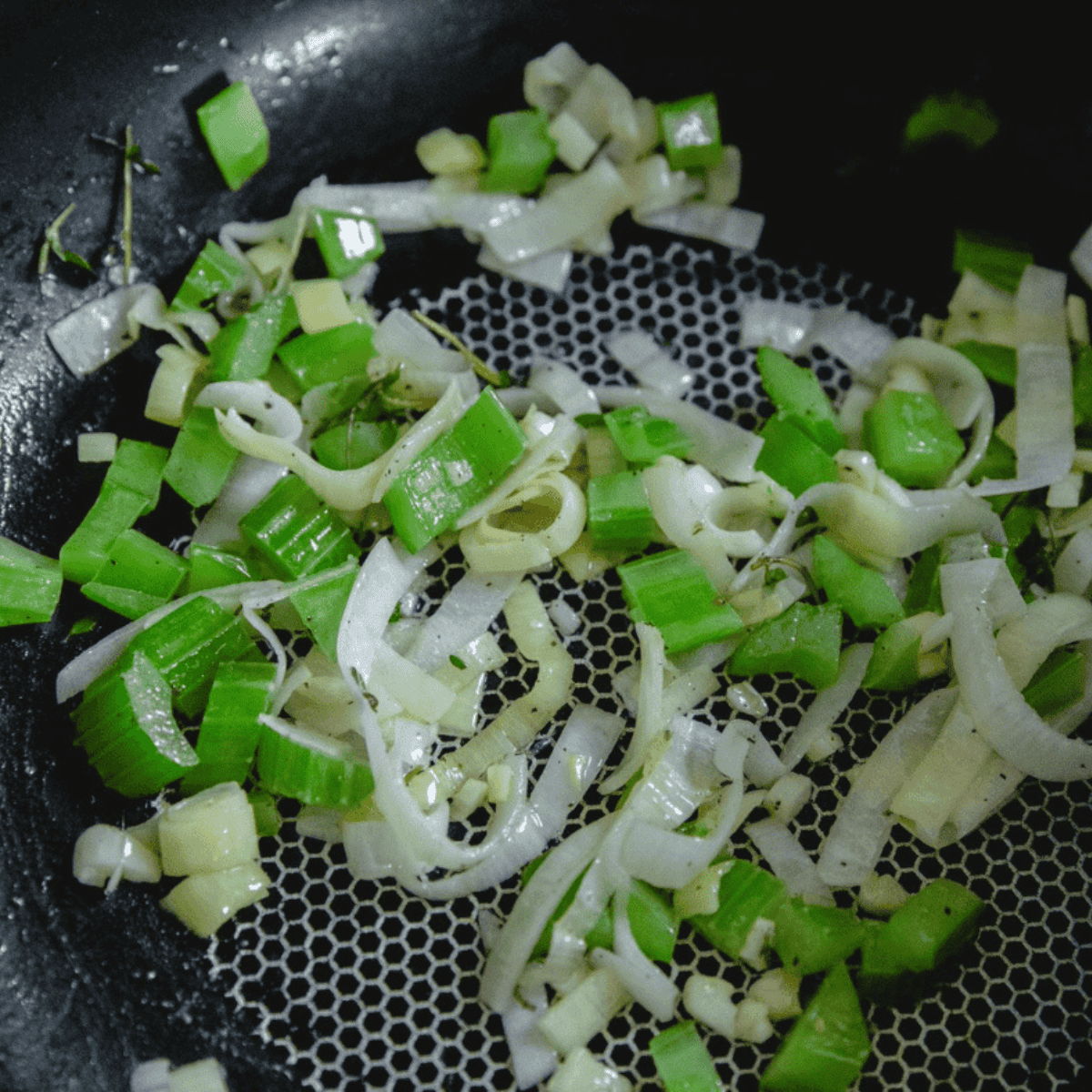 Softened onion and celery cooked until fragrant for cornbread dressing