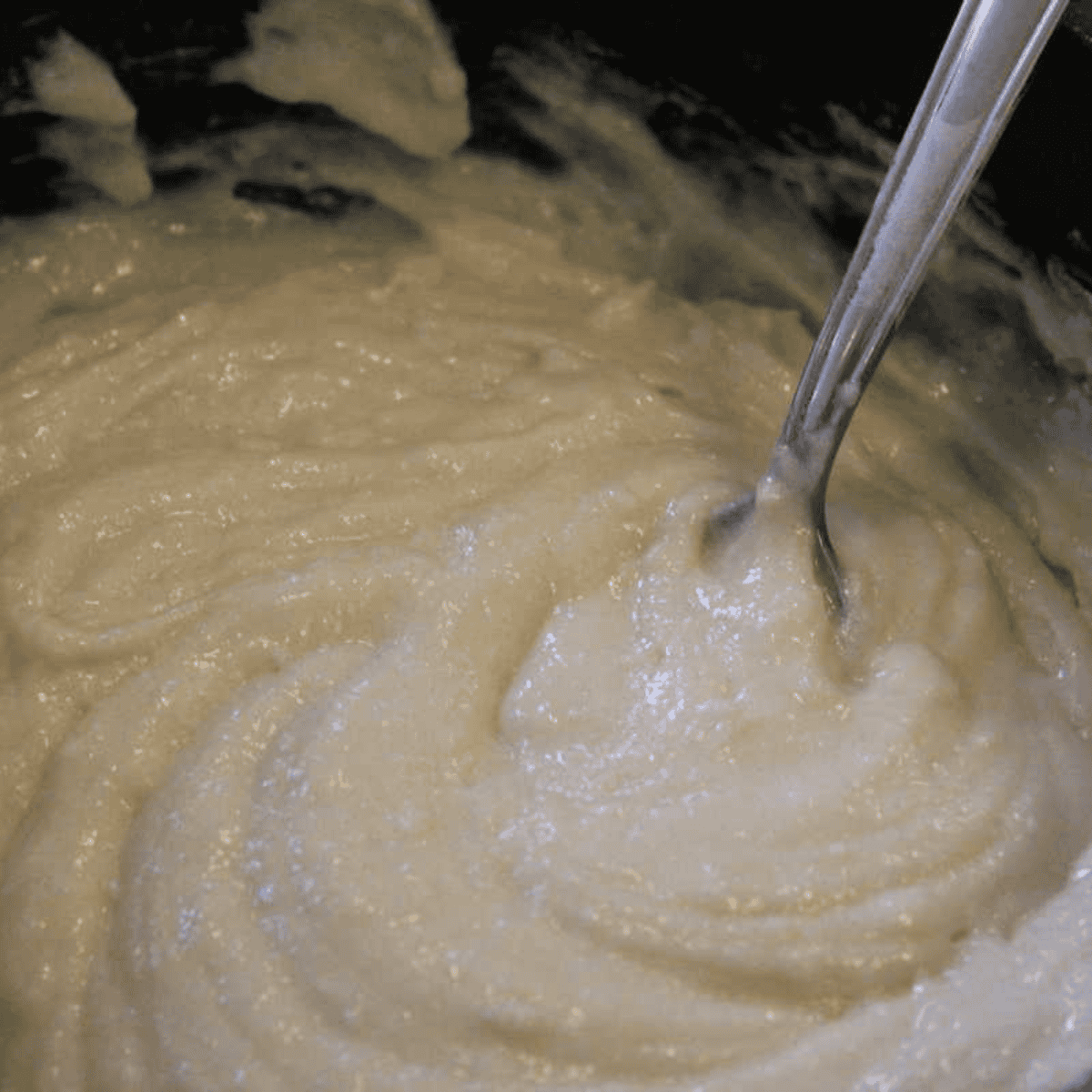 Milk stirred into the dry ingredients to form cobbler batter