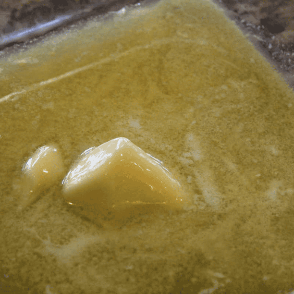 Melted butter poured into the bottom of an 8x8 baking pan