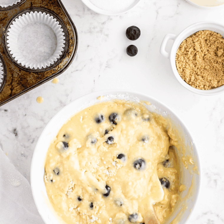 Gently stirring wet mixture into dry ingredients without overmixing.