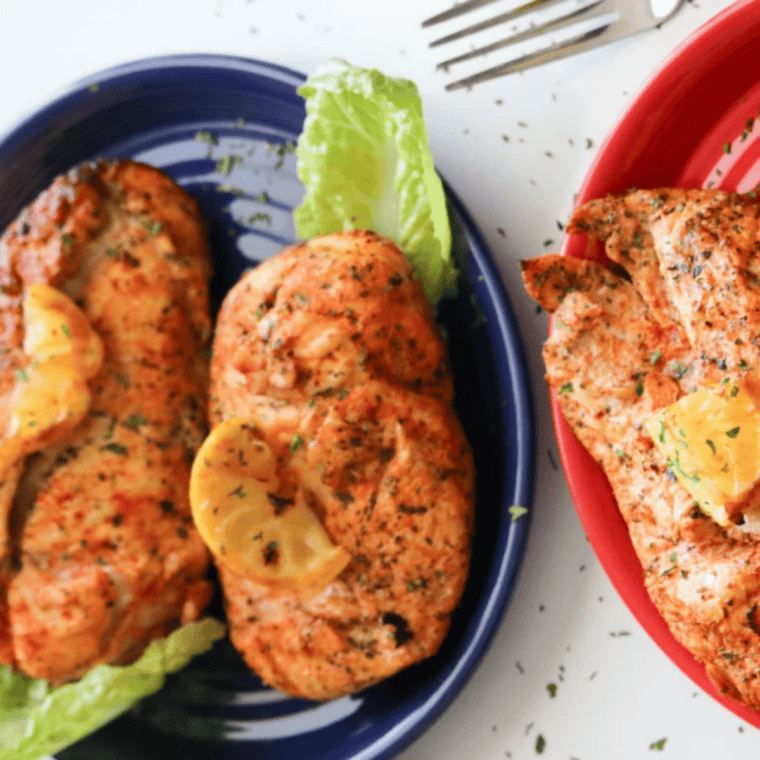 Air fryer lemon pepper chicken served on a plate, garnished with lemon and ready in 30 minutes