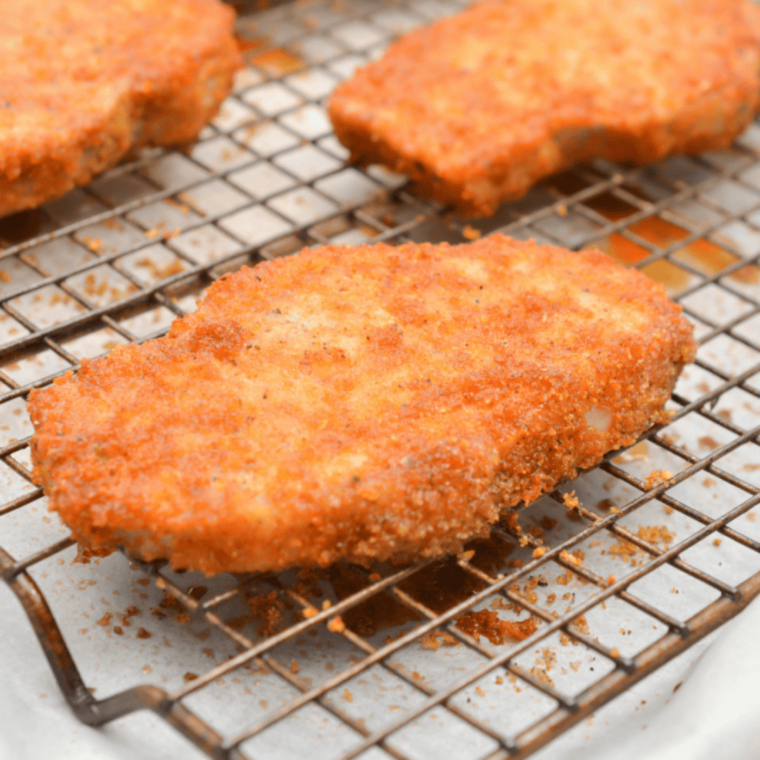 Crispy BBQ glazed Shake and Bake chicken on a baking sheet with golden breadcrumb coating and glossy barbecue glaze.