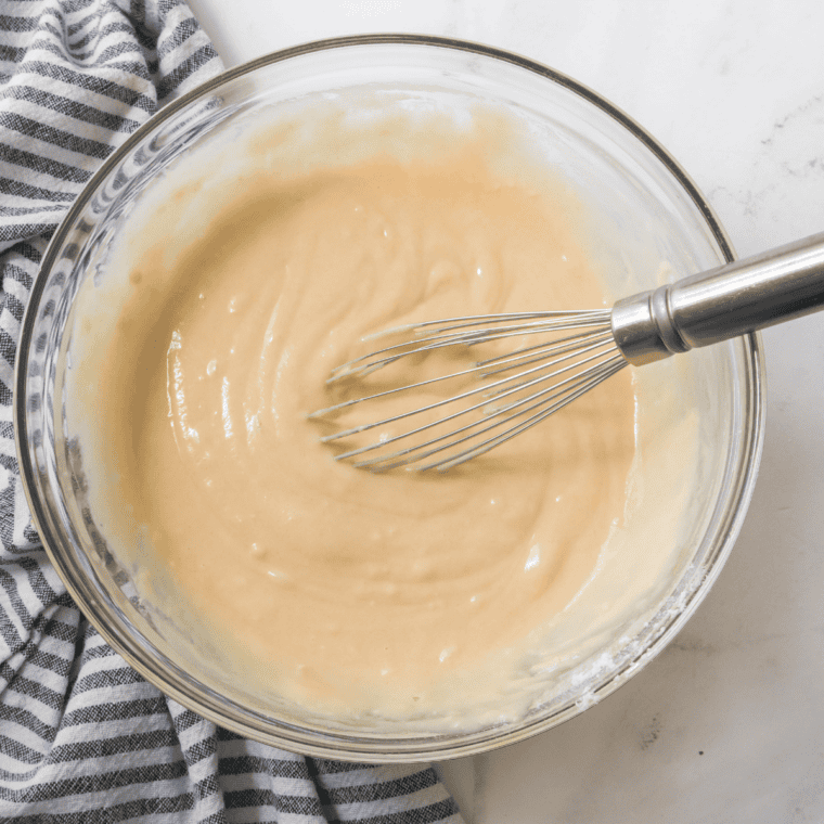 Lemon ricotta cake batter with egg yolks, sugar, and ricotta mixed until smooth