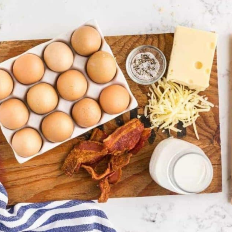 Ingredients needed for Air Fryer Bacon and Egg Quiche Lorraine on kitchen table.