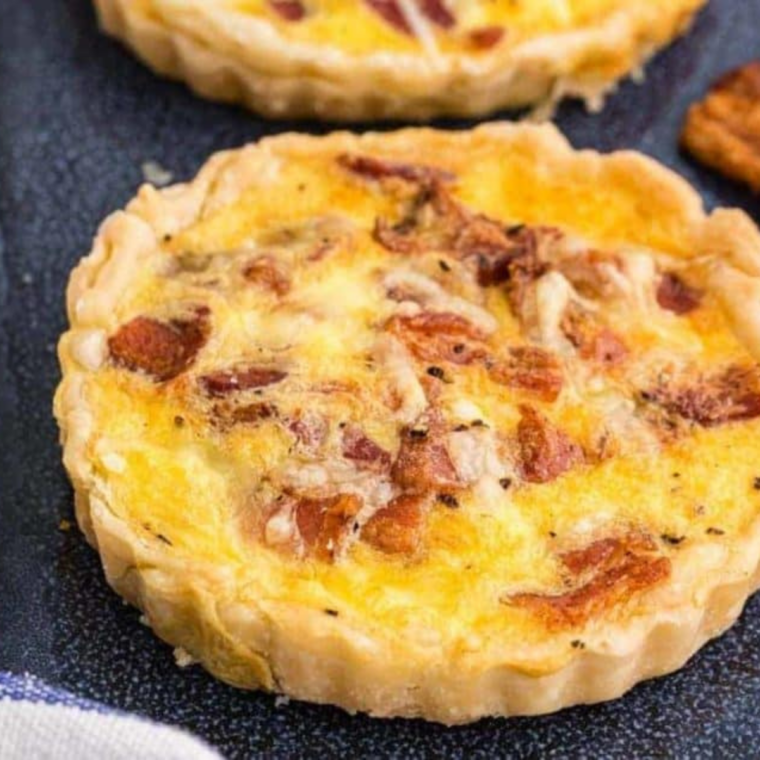 Air Fryer Bacon and Egg Quiche Lorraine with golden crust, cooked eggs, crispy bacon, and melted cheese, ready to serve.