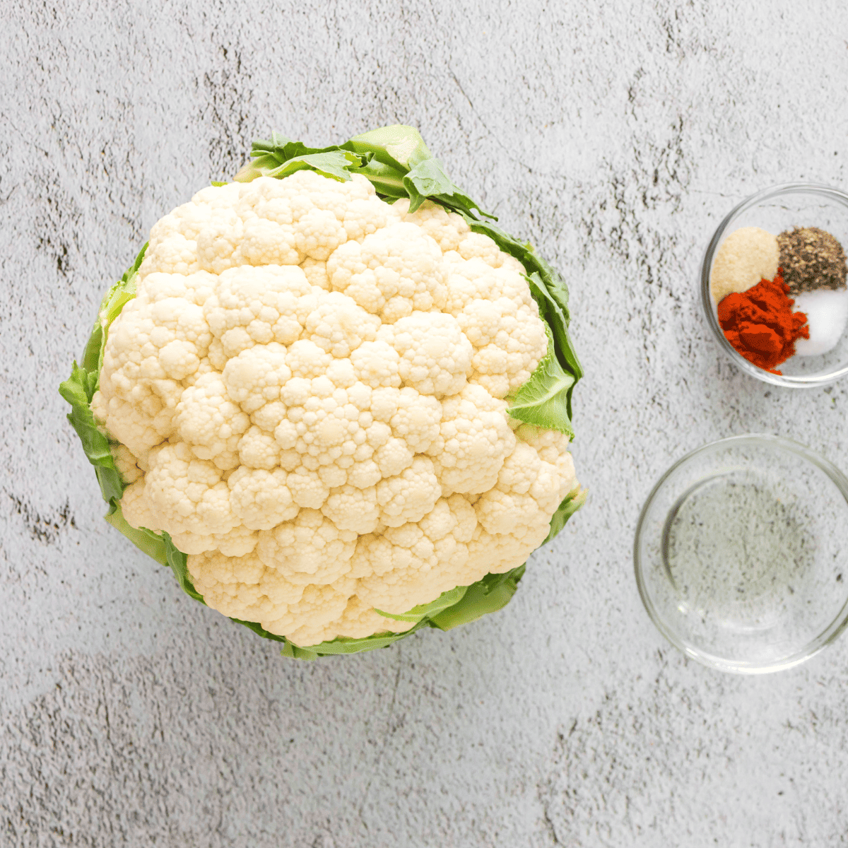 Ingredients needed for 15-Minute Crispy Air Fryer Cauliflower on kitchen table.