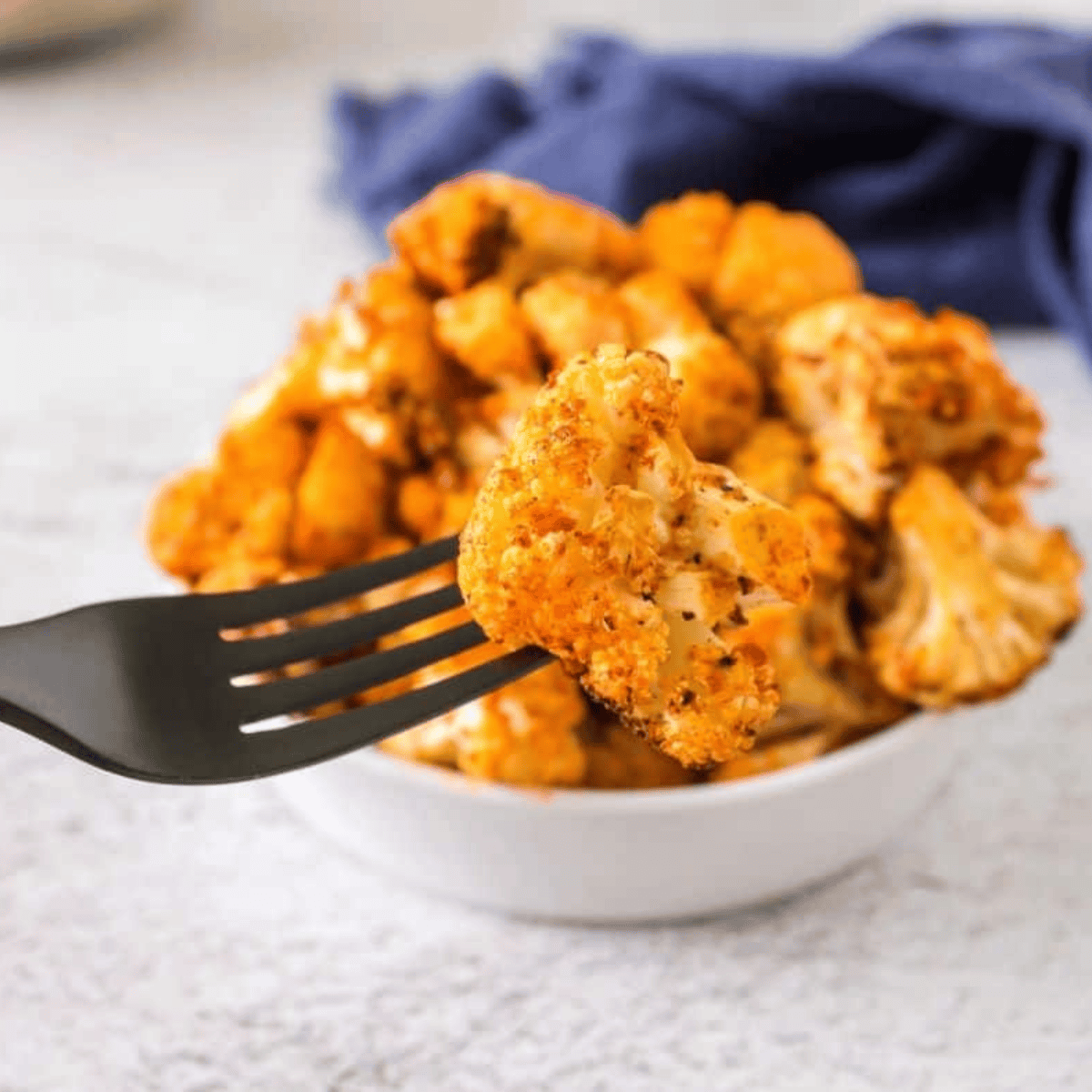 Golden, crispy air fryer cauliflower served immediately as a snack, appetizer, or side dish.