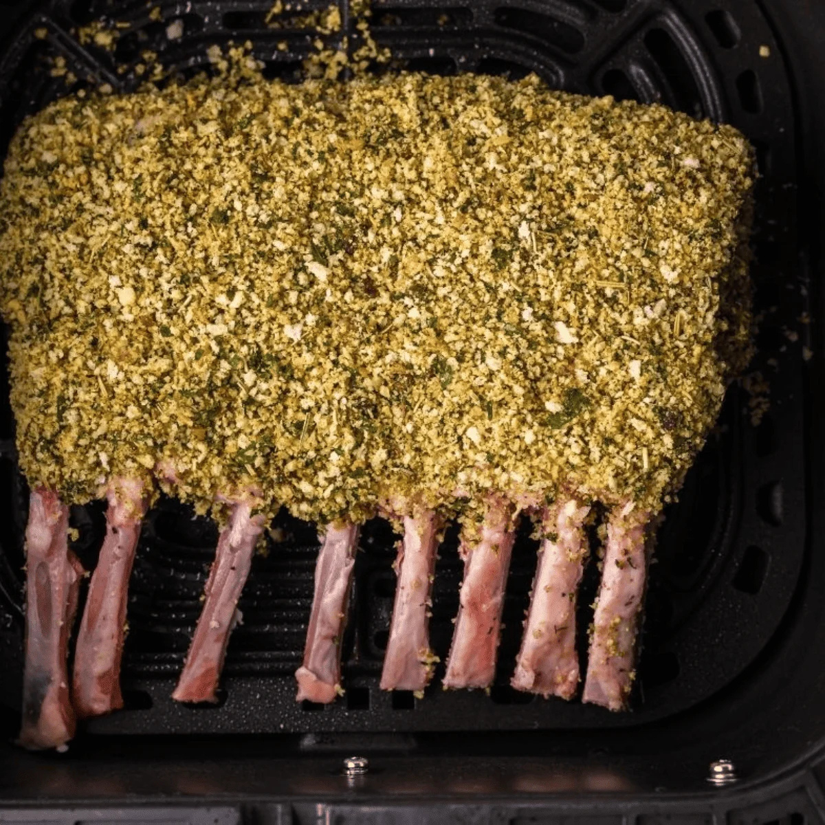 Rack of lamb brushed with olive oil and coated in a garlic-herb seasoning mixture