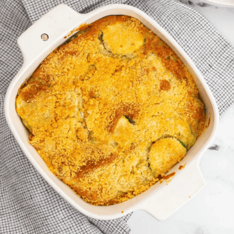 Golden and crispy air fryer zucchini casserole with melted cheese and fresh herbs.