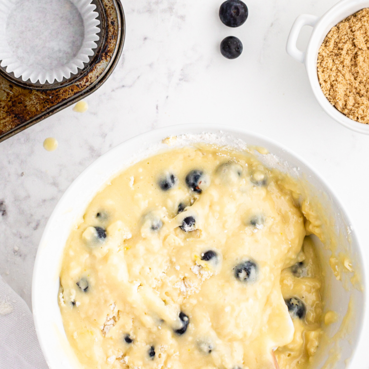Folding wet and dry ingredients with a spatula until the batter is lumpy