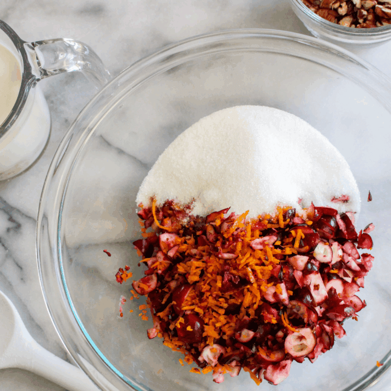 Folding fresh cranberries gently into muffin batter