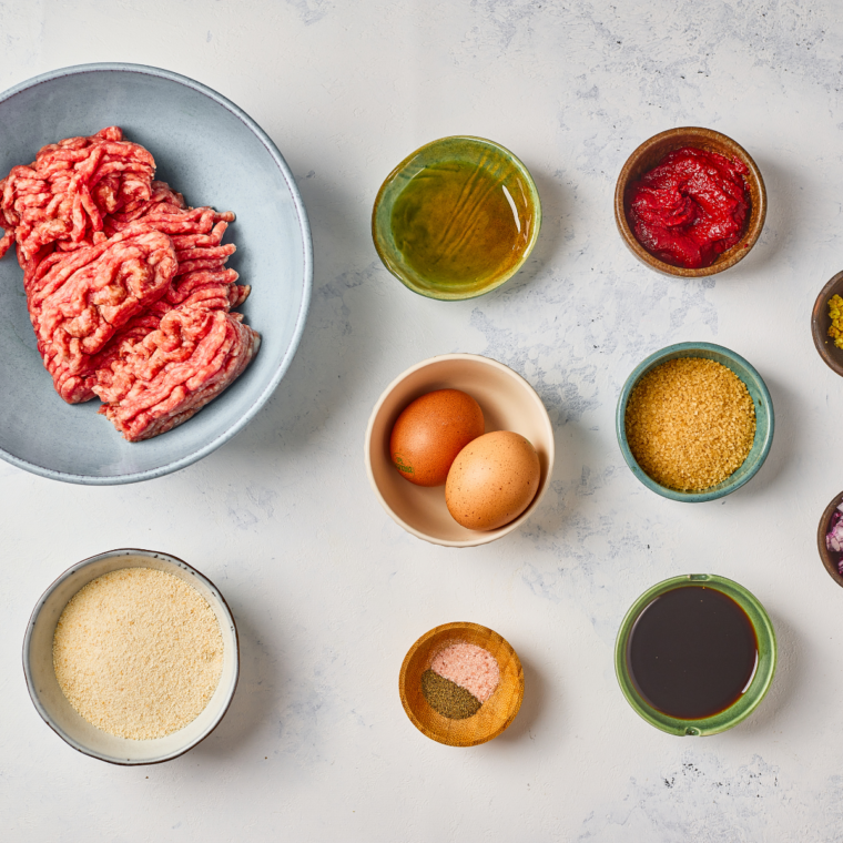 Hoisin Glazed MeatballsGround beef, panko, egg, fresh ginger, scallions, and a jar of hoisin sauce arranged in prep bowls
