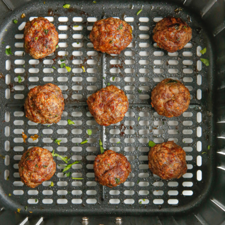 Instant-read thermometer reading 160°F in the center of an air fryer meatball