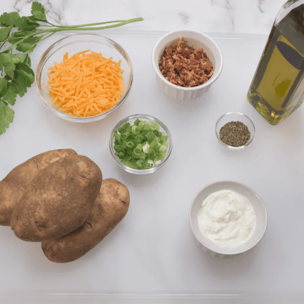 Ingredients for air fryer jacket potatoes: potatoes, olive oil, and sea salt
