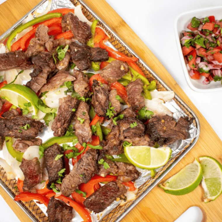 Cooked steak resting on a cutting board, then sliced thin against the grain for tacos