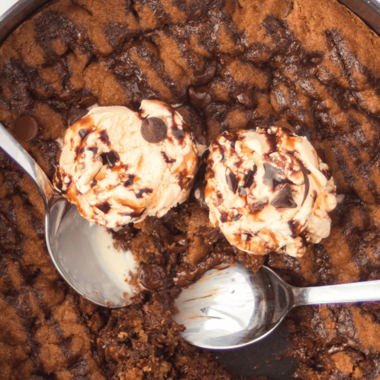 Golden, gooey chocolate chip skillet cookie fresh from the air fryer, loaded with melted chocolate chips.