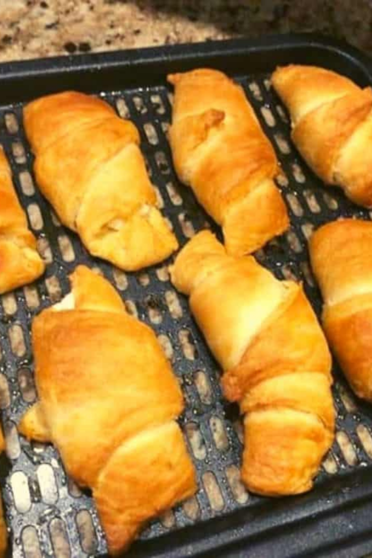 Crescent rolls arranged in air fryer basket ready for cooking at 340°F.