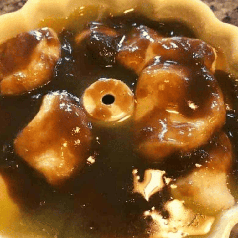 Melted butter and brown sugar stirred together in a bowl to make the monkey bread glaze