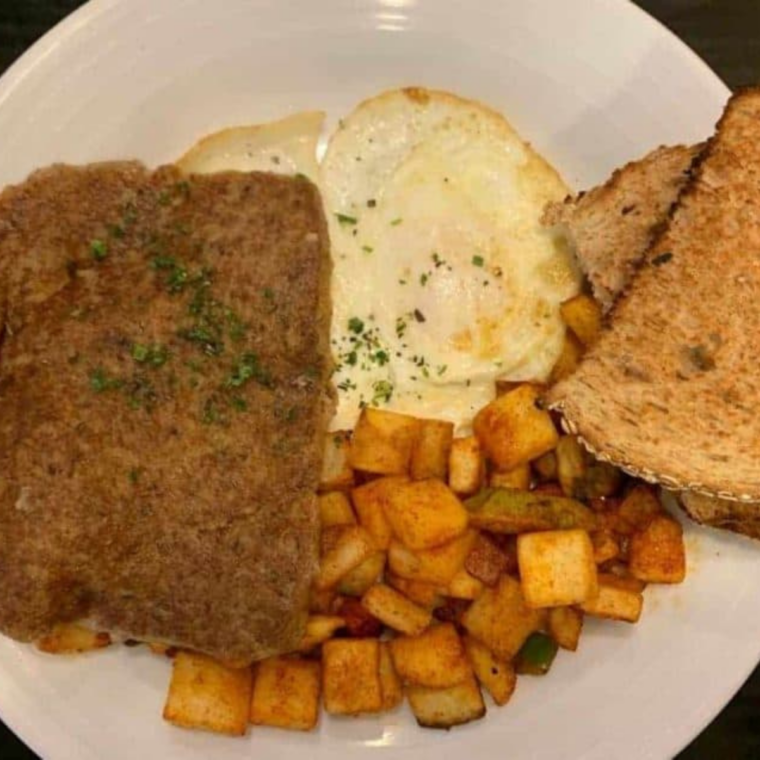 Close-up of crispy browned air fryer scrapple slices on a plate