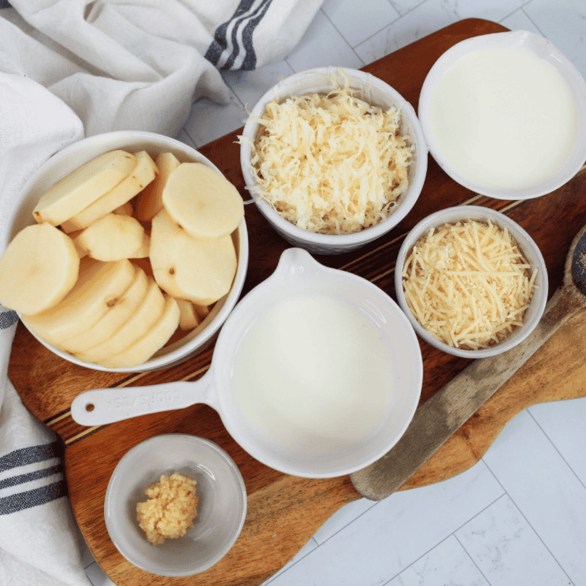 Ingredients needed for Air Fryer Au Gratin Potatoes on kitchen table.