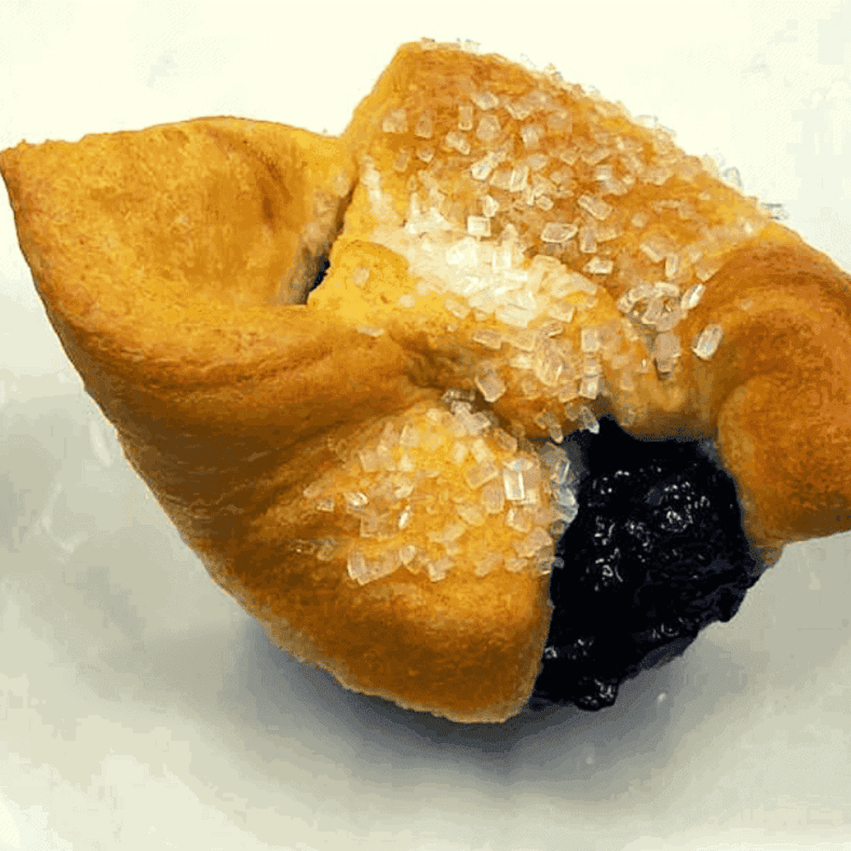 Golden air fryer blueberry crescent roll muffins with flaky layers and juicy blueberry filling, freshly baked and ready to enjoy.