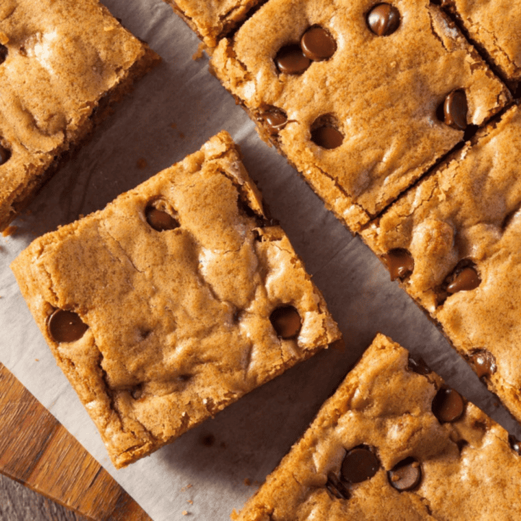 Thick, soft chocolate chip cookie bars baked in the air fryer with melted chocolate chips on top.