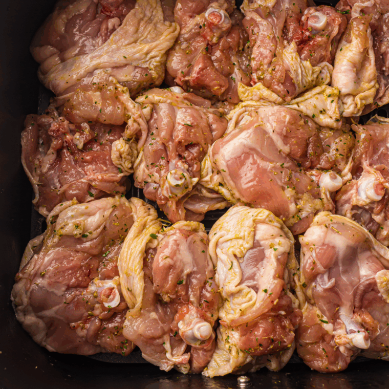 Place the chicken thighs into the air fryer basket.