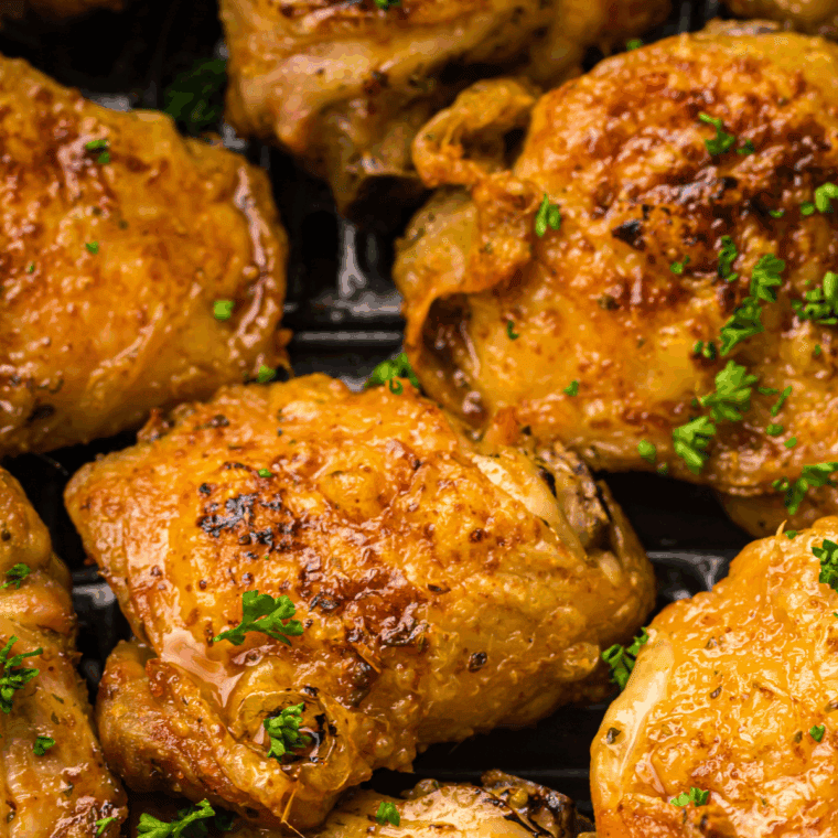 Air fryer honey garlic chicken thighs cooked golden brown and glazed with a sticky sweet garlic sauce.