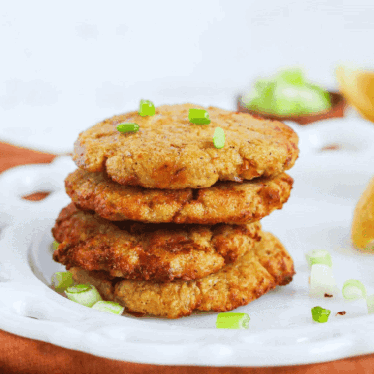 golden brown air fryer tuna patties served on a plate, crispy outside and tender inside