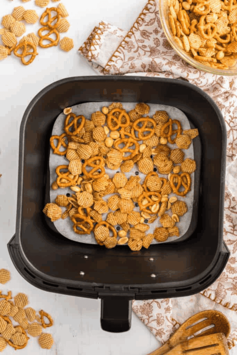 Chex Mix in the air fryer basket.