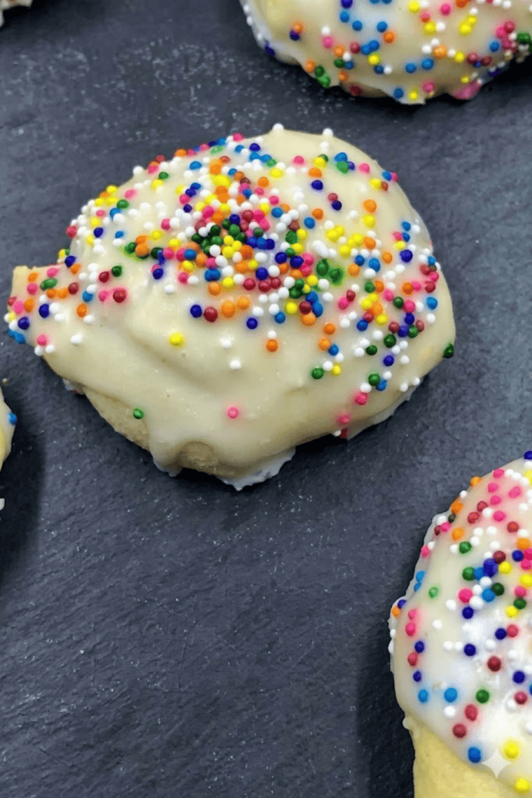 Soft and tender air fryer Italian cookies with glaze and sprinkles on a serving plate.