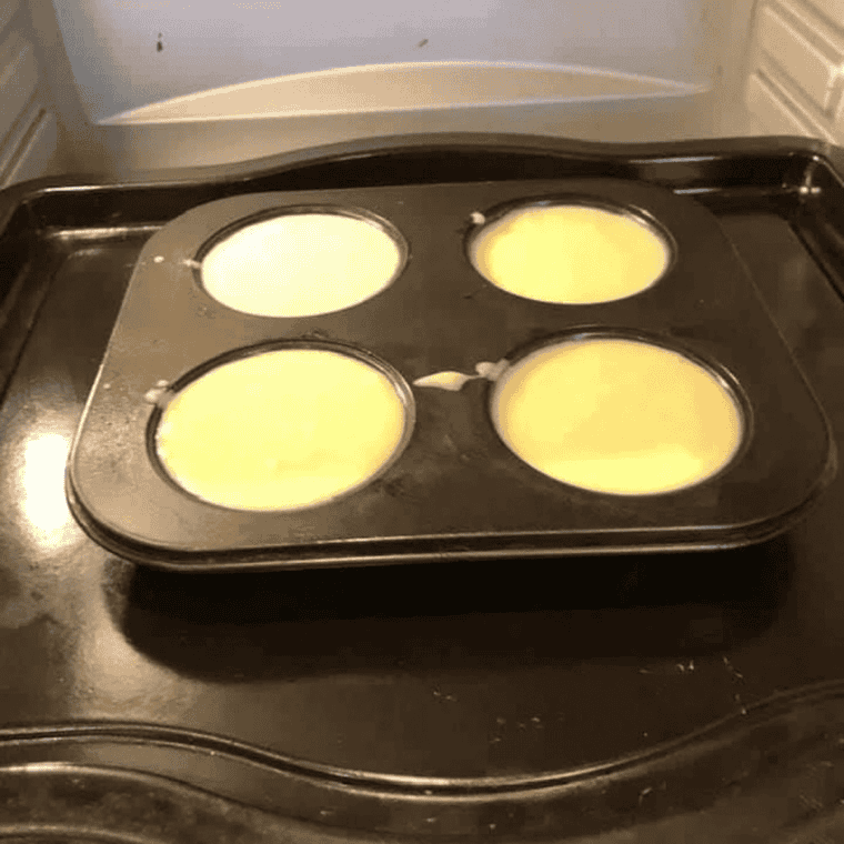 Cream cheese filling spooned over graham crusts in muffin liners, placed in the air fryer basket