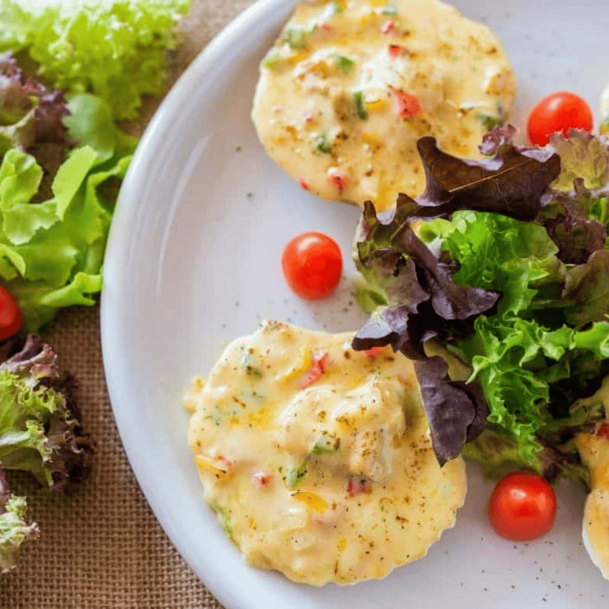 Golden-brown air fryer scallops on the half shell with creamy sauce and crispy breadcrumbs, garnished with parsley
