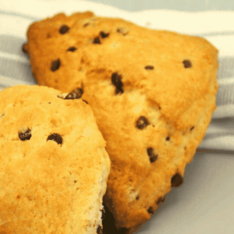 Freshly baked Air Fryer Chocolate Chip Scones on a plate, golden brown and studded with chocolate chips.