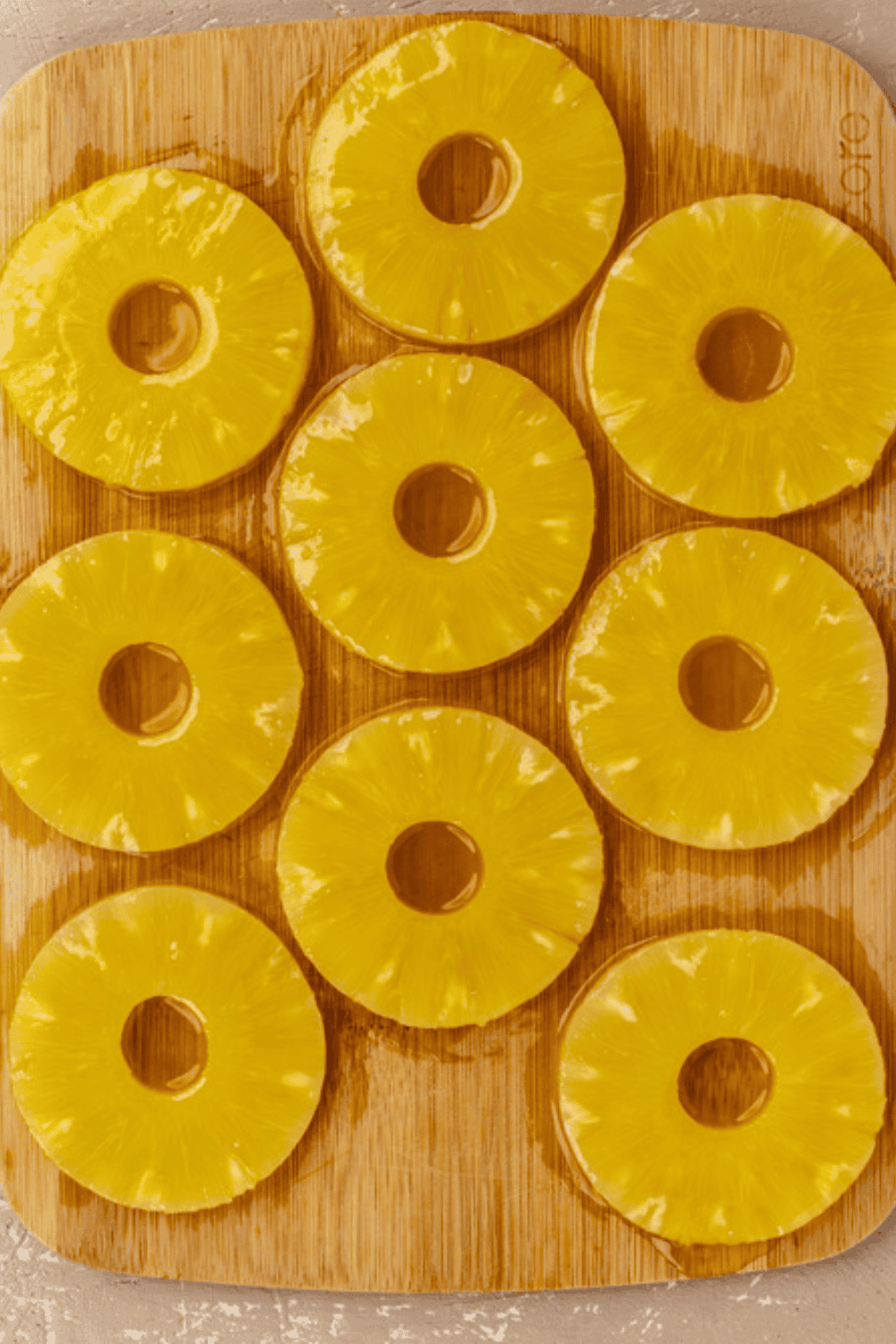 Pineapple pieces being coated evenly with brown sugar spice mixture.
