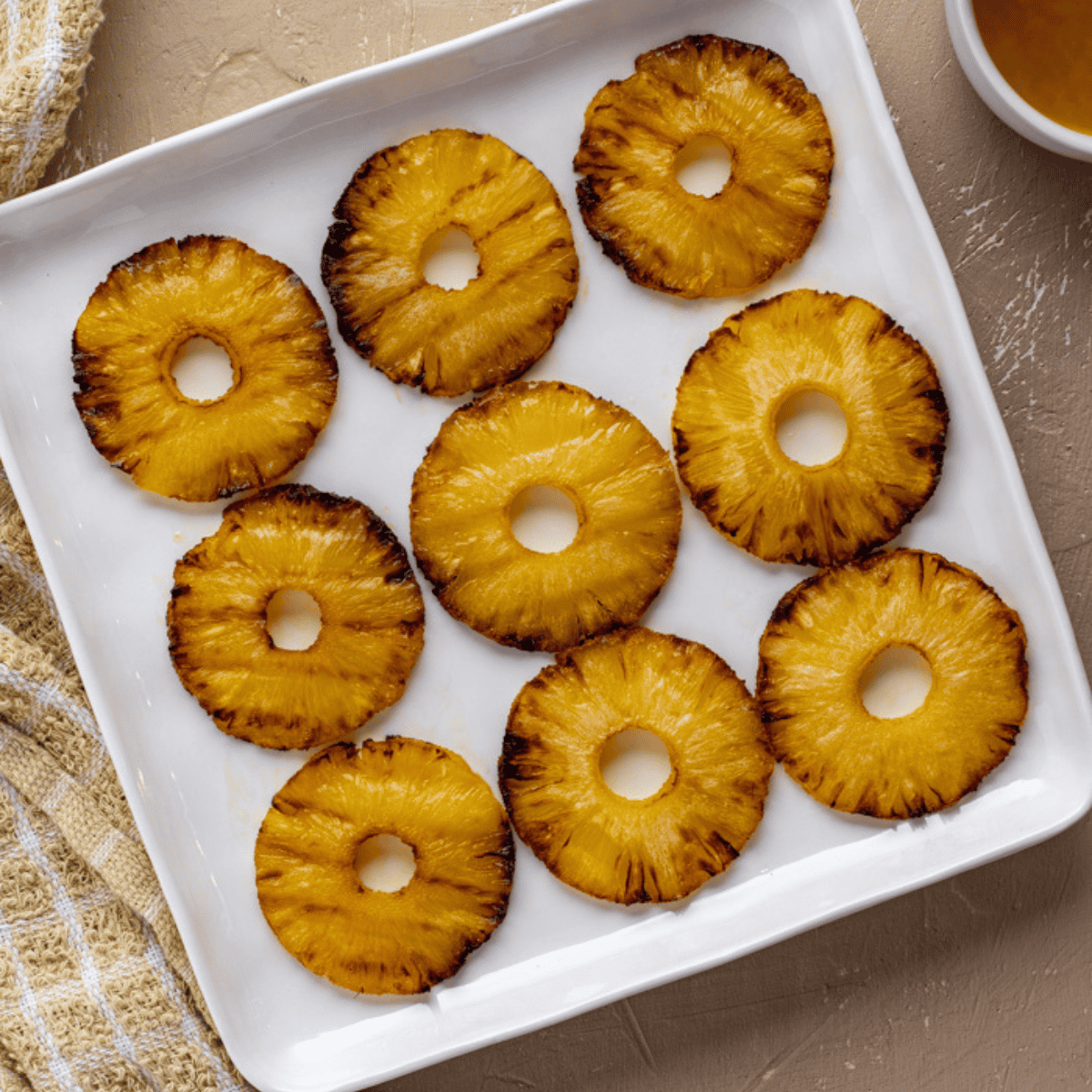 Caramelized Brazilian pineapple slices cooked in the air fryer, golden and juicy.