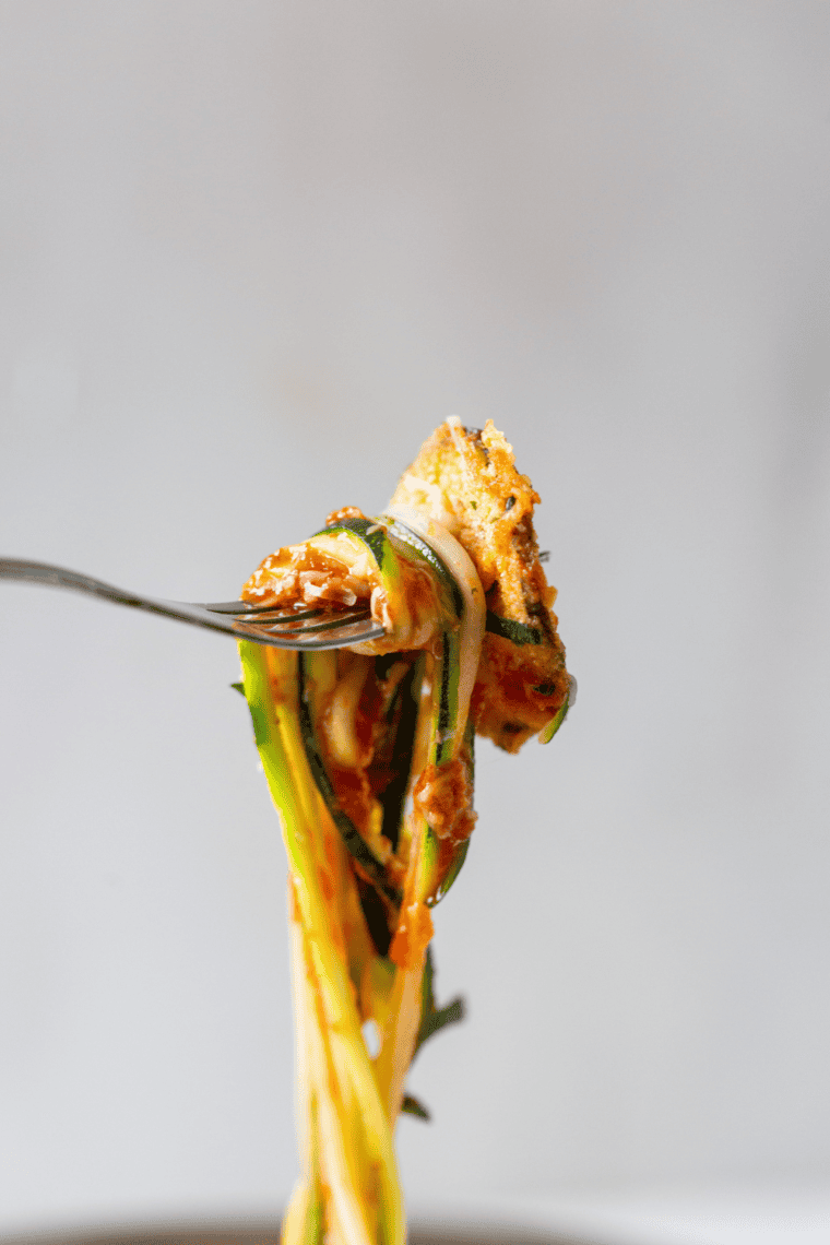Fresh zucchini noodles cooked in the air fryer, lightly crisp and served as a healthy low-carb pasta alternative.