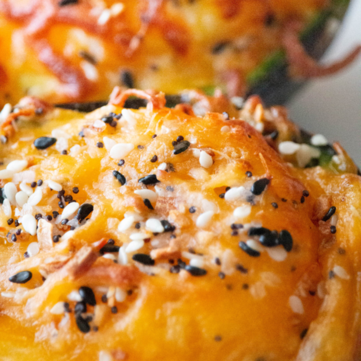 Air fryer avocado halves filled with cooked eggs, garnished with herbs, ready to serve.