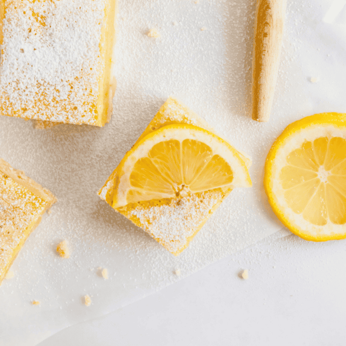 Lemon protein bars cut into squares, topped with a light lemon glaze, ready to serve.
