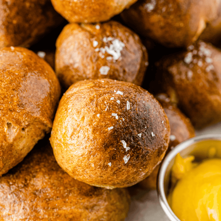 Homemade soft pretzel bites brushed with butter and sprinkled with salt, served warm with dipping sauce for snacking and game day appetizers