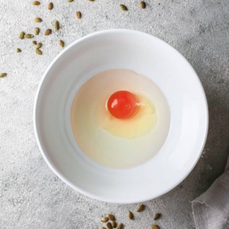 Egg and canola oil beaten together in a glass mixing bowl